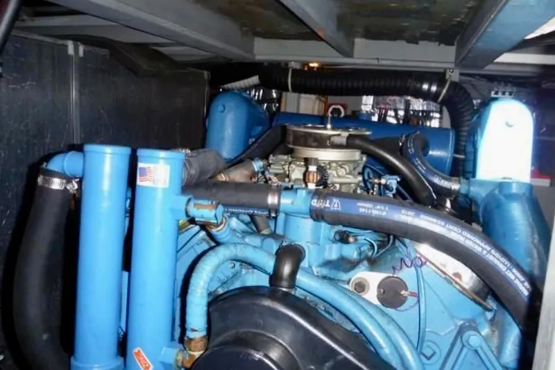 Slide: The Image of Engine compartment of 1987 Tollycraft 44 Cockpit Motor Yacht, featuring blue engine components. - 18