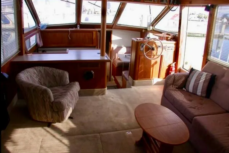 Slide: The Image of Interior of 1987 Tollycraft 44 Cockpit Motor Yacht with cozy seating and helm. - 7