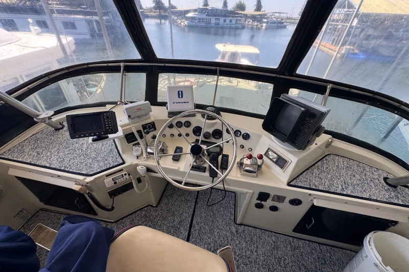 Slide: The Image of 1987 Tollycraft 44 Cockpit Motor Yacht helm with navigation equipment and steering wheel. - 16