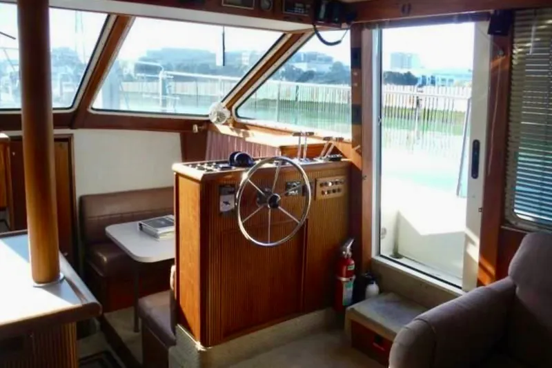 Slide: The Image of Interior of 1987 Tollycraft 44 Cockpit Motor Yacht with helm and seating area. - 6