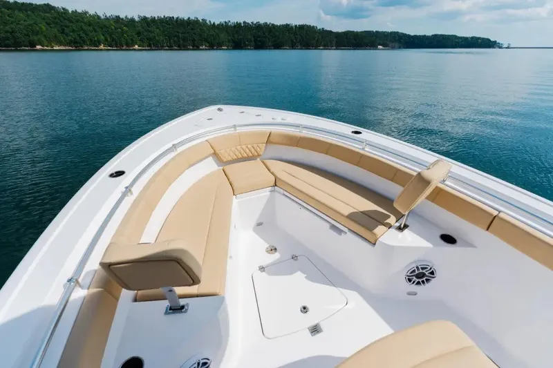 Slide: The Image of 2027 Sportsman Heritage 251 Center Console boat with tan seating on calm water. - 4