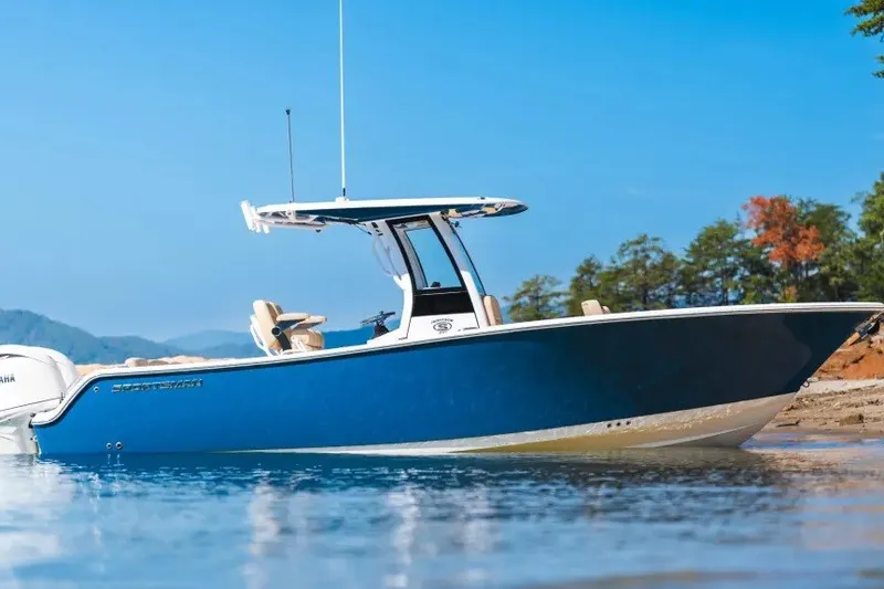 Slide: The Image of 2027 Sportsman Heritage 251 Center Console boat on calm water, blue sky background. - 3