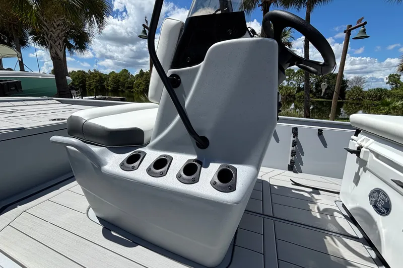 Slide: The Image of 2027 Tracker Bass Tracker Classic CC boat console with rod holders and steering wheel. - 13