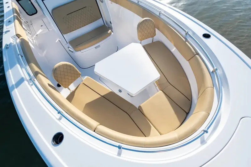 Slide: The Image of 2027 Sportsman Open 252 Center Console boat with tan seating and white table. - 6