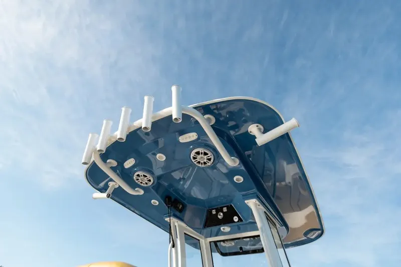 Slide: The Image of 2027 Sportsman Open 252 Center Console boat top view with rod holders and speakers. - 9