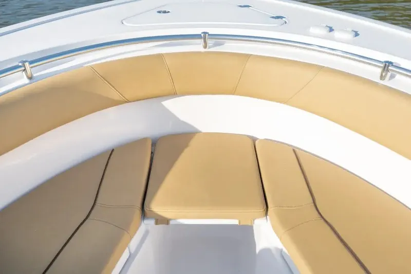 Slide: The Image of 2027 Sportsman Open 252 Center Console boat with tan cushioned seating. - 2