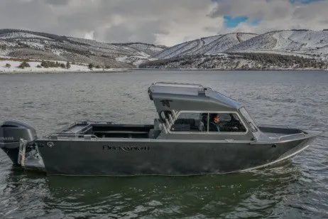 The Image of Duckworth 23 Navigator 2027 boat on a scenic lake with snowy hills in the background. - 0