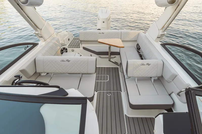 Slide: The Image of Interior of a Sea Ray SDX 270 Outboard with sleek gray seating and a wooden table. - 17