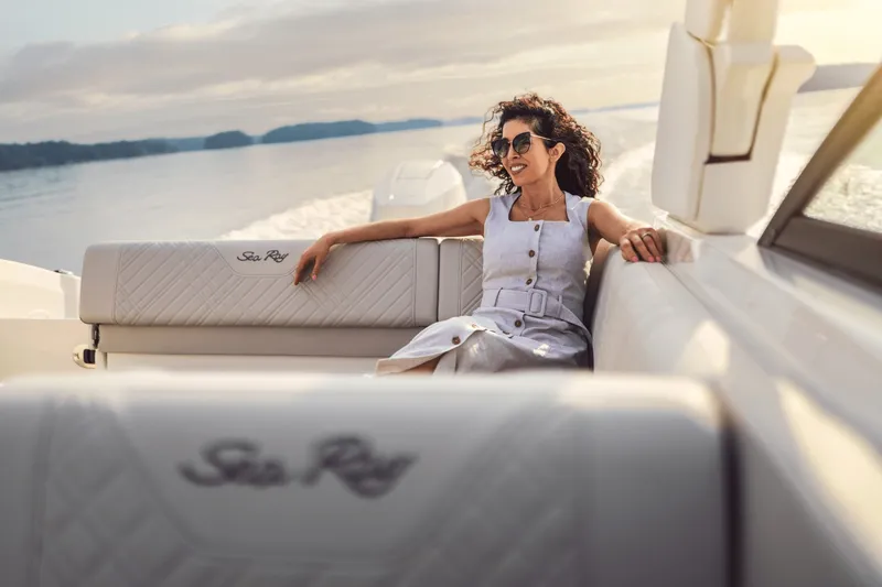 Slide: The Image of Woman relaxing on a Sea Ray SDX 270 Outboard, surrounded by water and soft light. - 37