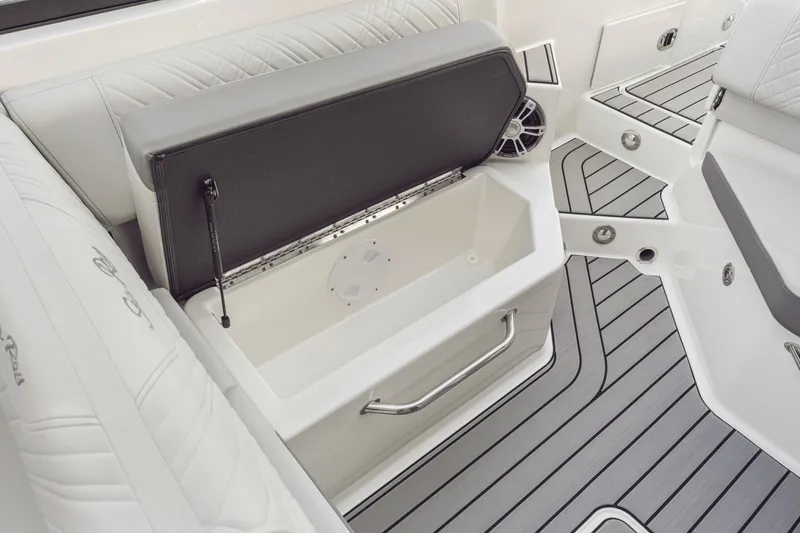 Slide: The Image of The image shows the interior of a 2027 Sea Ray SDX 270 Outboard with gray upholstery and a storage compartment. - 15