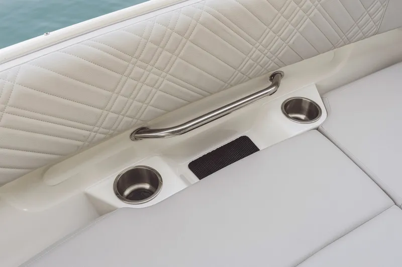 Slide: The Image of Close-up of a white seating area with quilted pattern, stainless steel handle, and two cup holders. - 19
