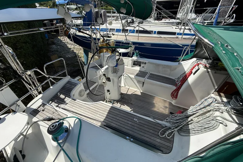Slide: The Image of Cockpit of 2003 Beneteau Oceanis Clipper 393 sailboat with green canopy and ropes. - 9