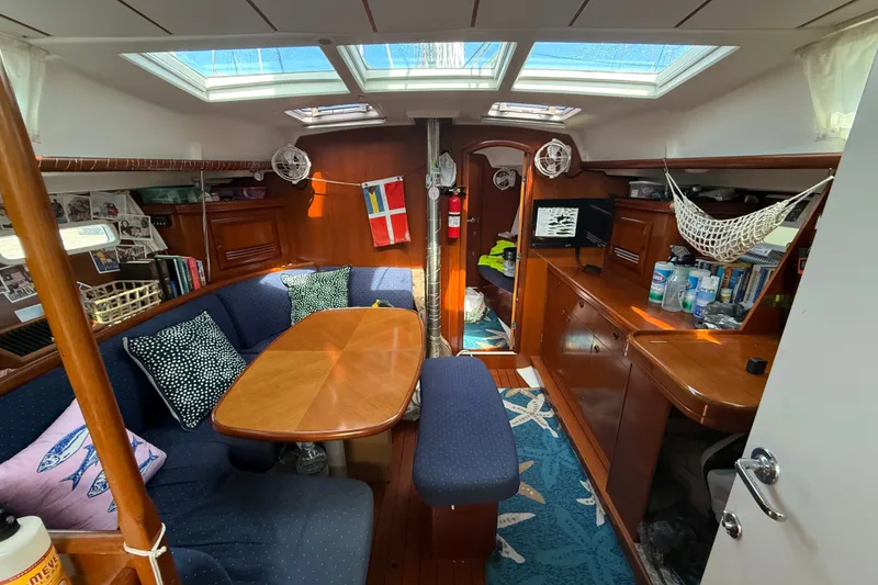 Slide: The Image of Cozy interior of 2003 Beneteau Oceanis Clipper 393 sailboat with dining area and storage. - 14