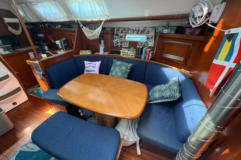 Slide: The Image of Interior of 2003 Beneteau Oceanis Clipper 393 yacht with cozy seating and wooden table. - 15