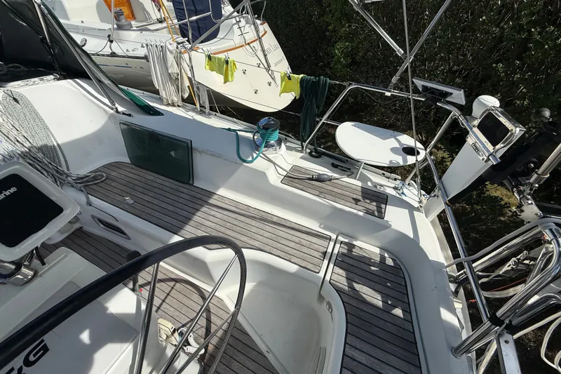 Slide: The Image of Cockpit of 2003 Beneteau Oceanis Clipper 393 sailboat with teak flooring and steering wheel. - 10