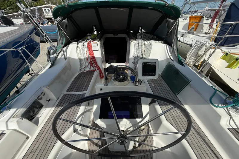 Slide: The Image of Cockpit of 2003 Beneteau Oceanis Clipper 393 sailboat with steering wheel and navigation equipment. - 12