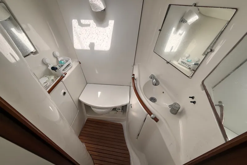 Slide: The Image of Bathroom interior of 2003 Beneteau Oceanis Clipper 393 yacht, featuring sink and mirror. - 23