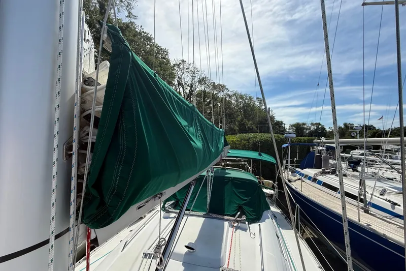 Slide: The Image of 2003 Beneteau Oceanis Clipper 393 sailboat docked with green sail cover. - 3