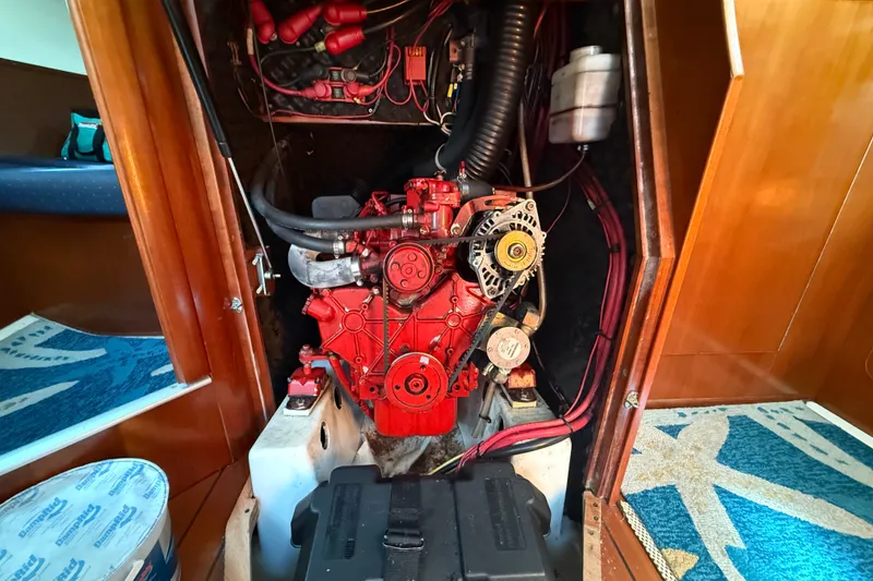 Slide: The Image of Engine compartment of a 2003 Beneteau Oceanis Clipper 393 sailboat, showcasing a red engine. - 19