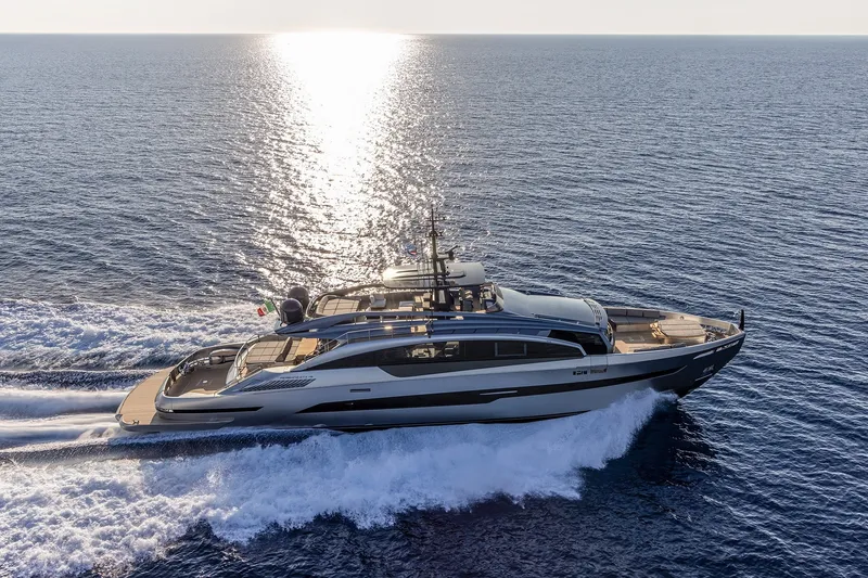 Slide: The Image of Luxurious 2026 Pershing GTX116 yacht cruising on open sea at sunset. - 0