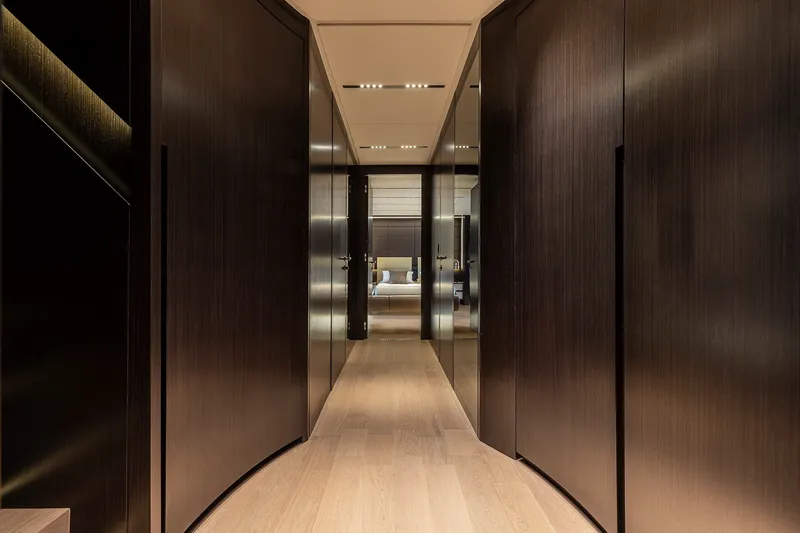 Slide: The Image of Luxurious interior hallway of 2026 Pershing GTX116 yacht with sleek wooden finishes. - 20