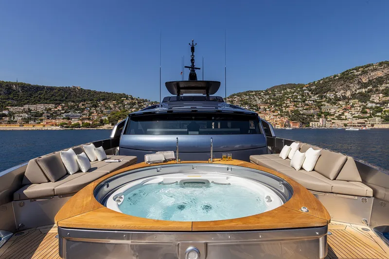 Slide: The Image of Luxurious 2026 Pershing GTX116 yacht with jacuzzi, scenic coastal backdrop. - 9