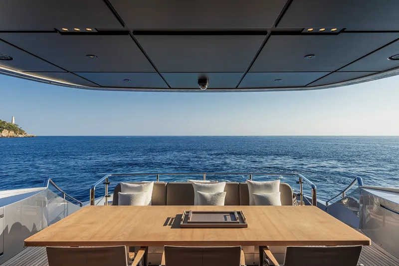 Slide: The Image of Luxury yacht Pershing GTX116, 2026 model, with elegant deck dining area overlooking the ocean. - 15