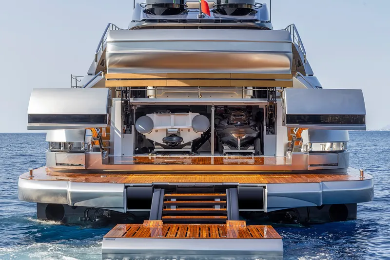 Slide: The Image of 2026 Pershing GTX116 yacht rear view with open garage and wooden deck. - 7
