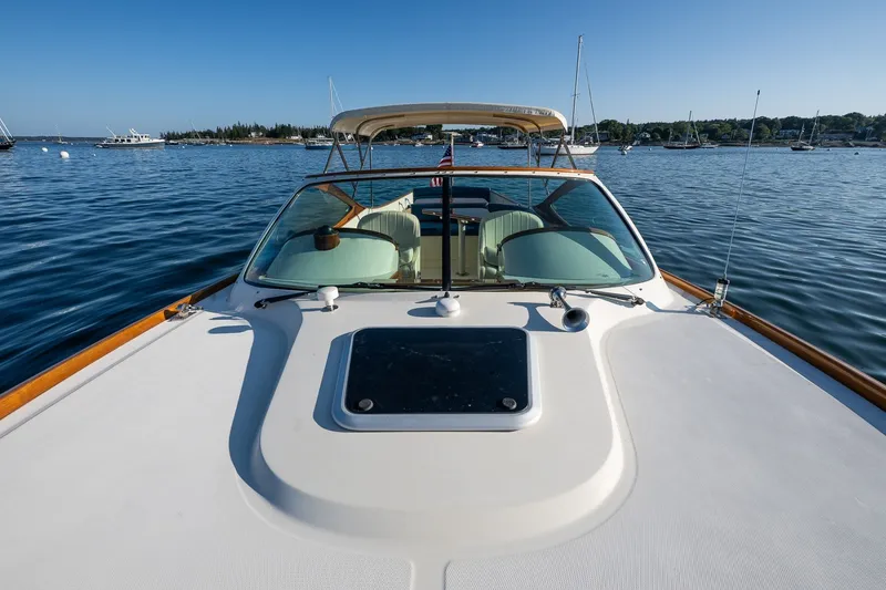 Slide: The Image of 2008 Hinckley Talaria 29R boat on calm water, showcasing sleek design and luxury features. - 13