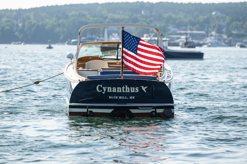 Slide: The Image of 2008 Hinckley Talaria 29R boat with American flag on water, Blue Hill, ME. - 9