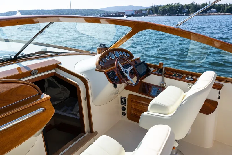 Slide: The Image of 2008 Hinckley Talaria 29R yacht cockpit with elegant wood finish and modern controls. - 18