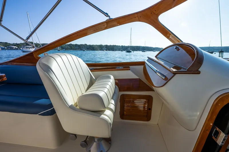 Slide: The Image of Interior of 2008 Hinckley Talaria 29R boat with elegant seating and wooden accents. - 20