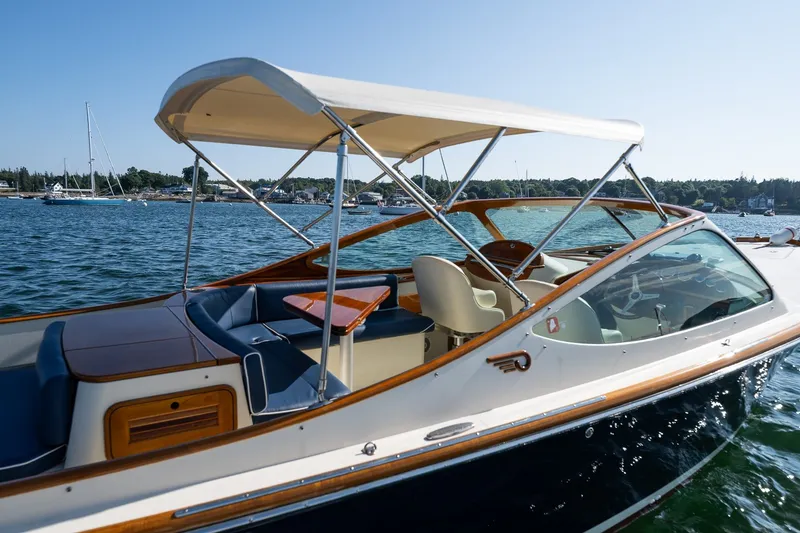 Slide: The Image of 2008 Hinckley Talaria 29R boat with canopy, docked on a sunny day. - 21