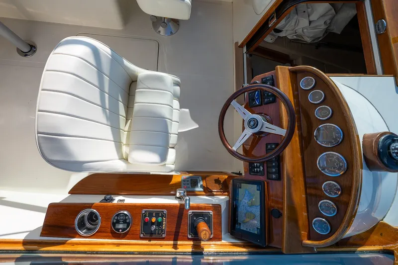 Slide: The Image of Cockpit of 2008 Hinckley Talaria 29R with white seat and wooden dashboard. - 17