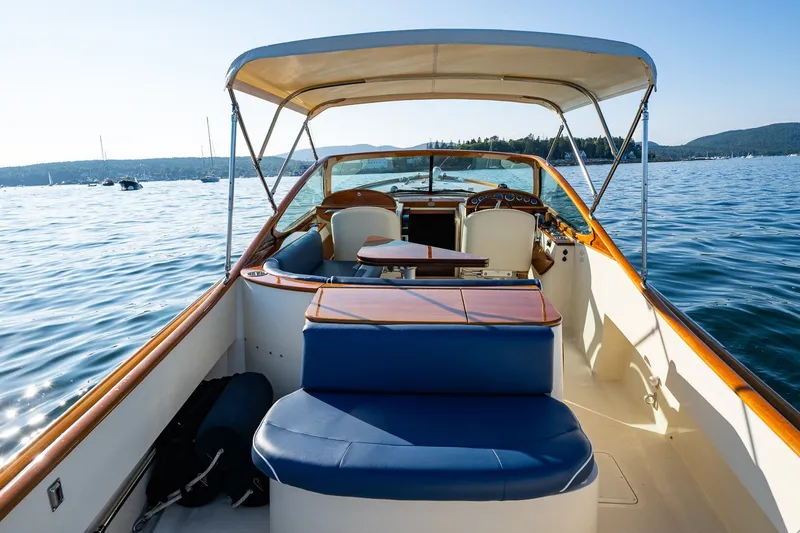Slide: The Image of 2008 Hinckley Talaria 29R boat interior with blue seating, on a sunny day at sea. - 26