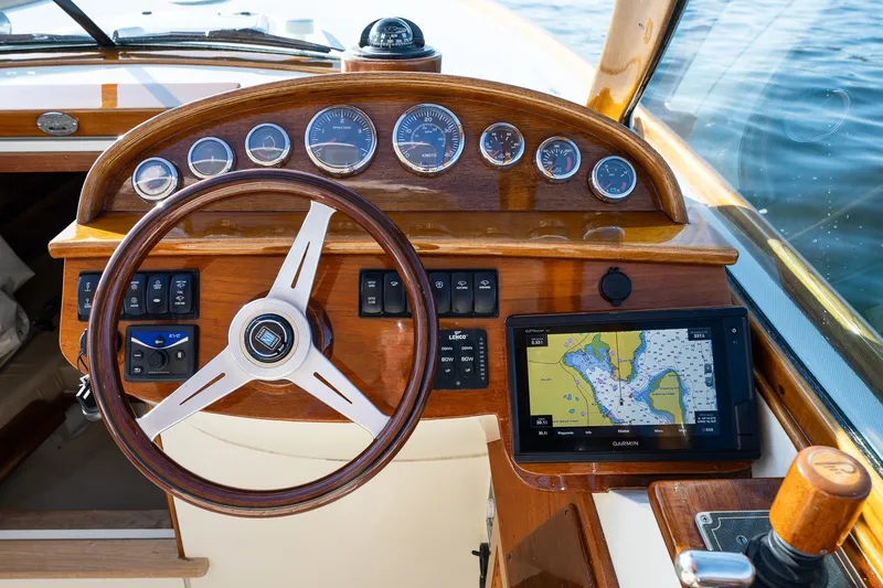 Slide: The Image of Helm of 2008 Hinckley Talaria 29R with wooden dashboard and Garmin navigation system. - 22