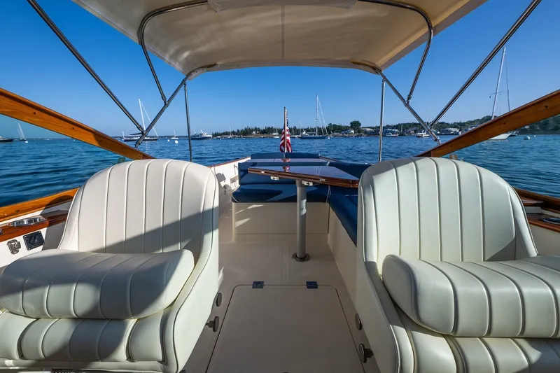 Slide: The Image of Interior view of 2008 Hinckley Talaria 29R boat with elegant seating and scenic water backdrop. - 23