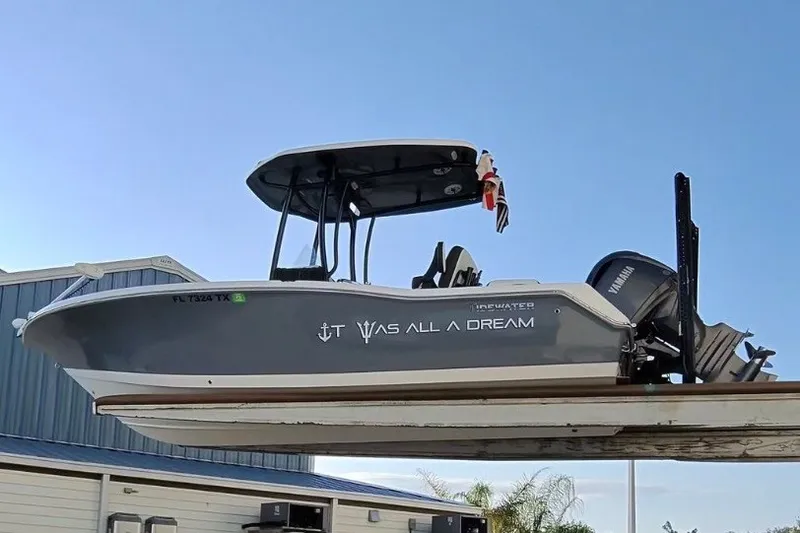 Slide: The Image of 2025 Tidewater 210 LXF boat with Yamaha engine, displayed on a lift against a clear sky. - 8