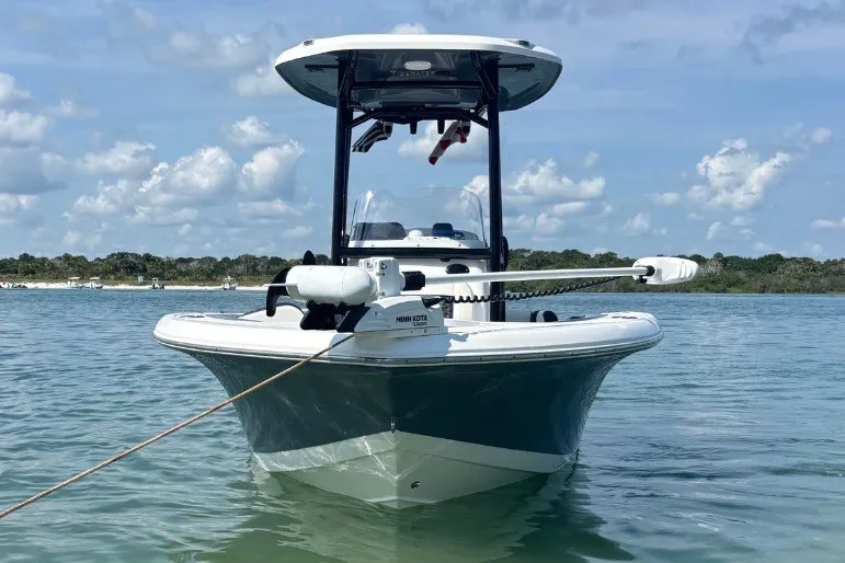 Slide: The Image of 2025 Tidewater 210 LXF boat on calm water under a clear sky. - 1