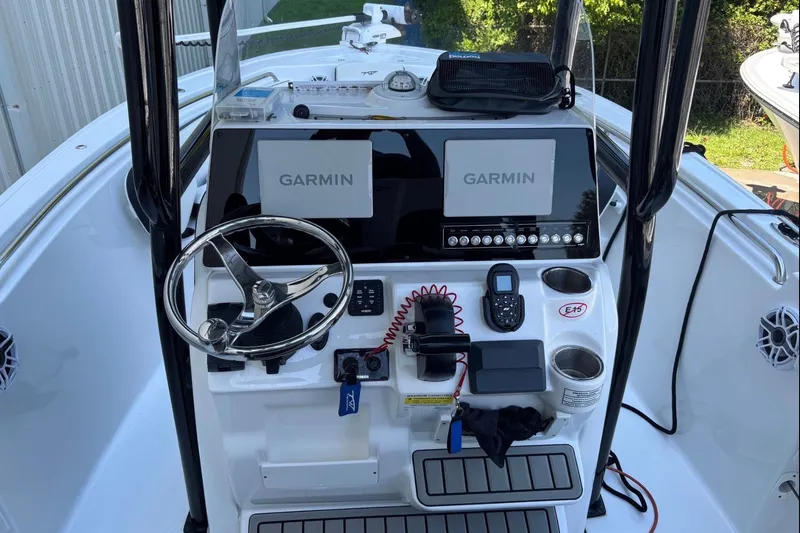 Slide: The Image of 2025 Tidewater 210 LXF boat console with Garmin displays and steering wheel. - 13