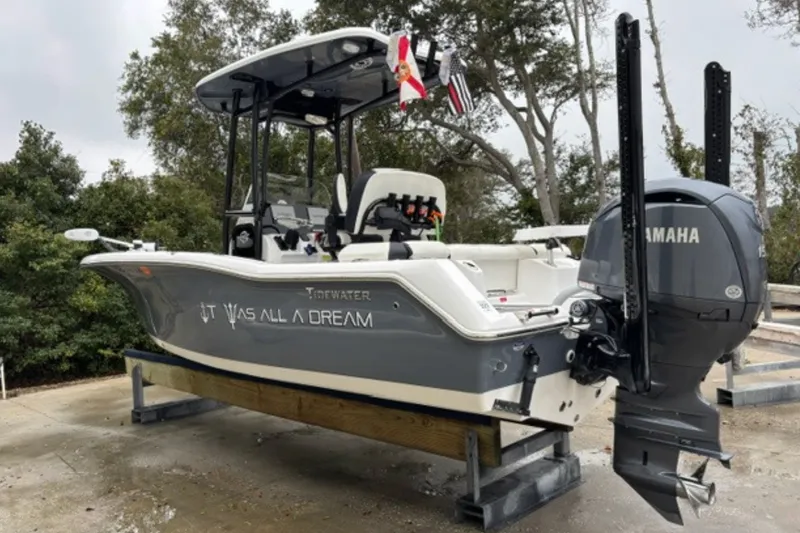 Slide: The Image of 2025 Tidewater 210 LXF boat with Yamaha engine, docked outdoors. - 6