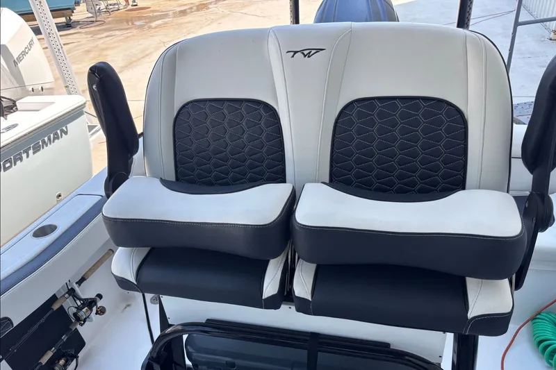 Slide: The Image of 2025 Tidewater 210 LXF boat seats with black and white cushioned design. - 14