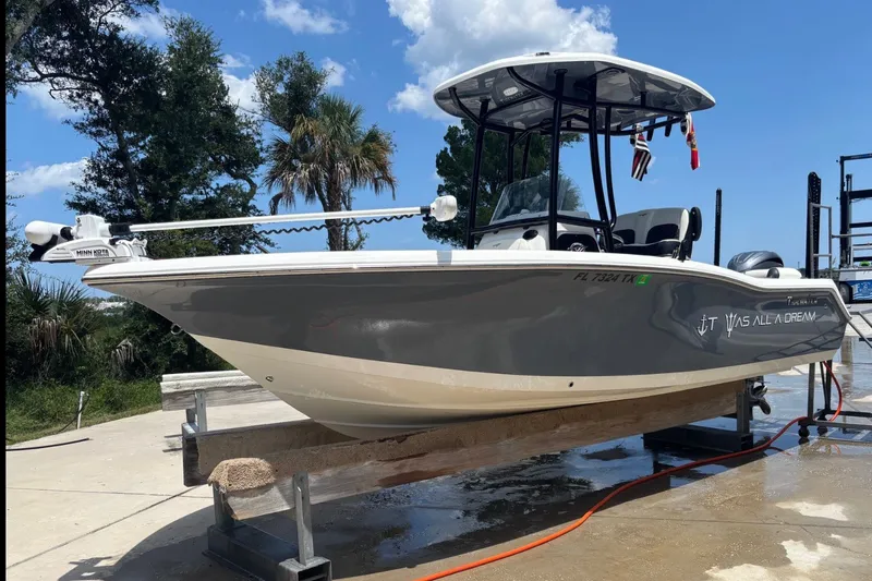 Slide: The Image of 2025 Tidewater 210 LXF boat on a lift, featuring sleek design and modern equipment. - 4