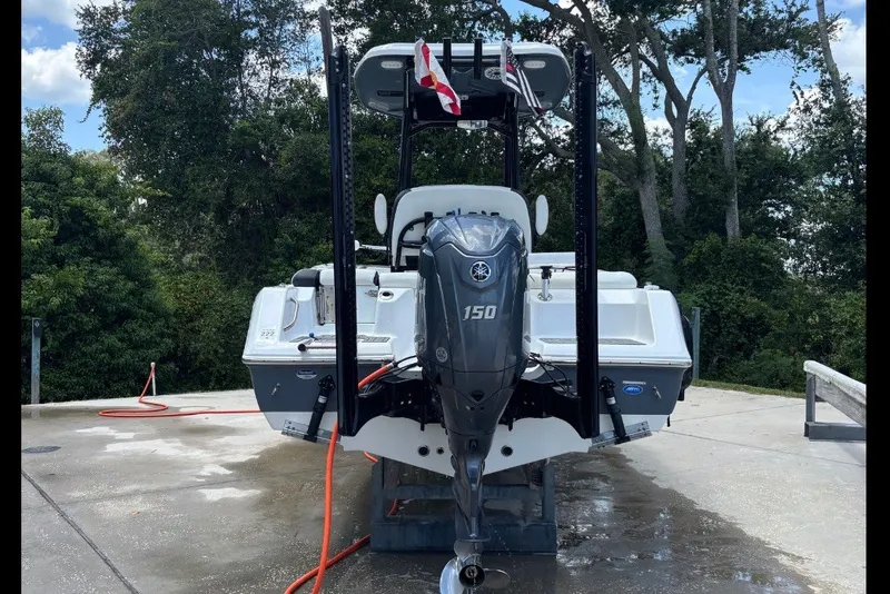 Slide: The Image of 2025 Tidewater 210 LXF boat with Yamaha 150 engine, docked outdoors. - 5