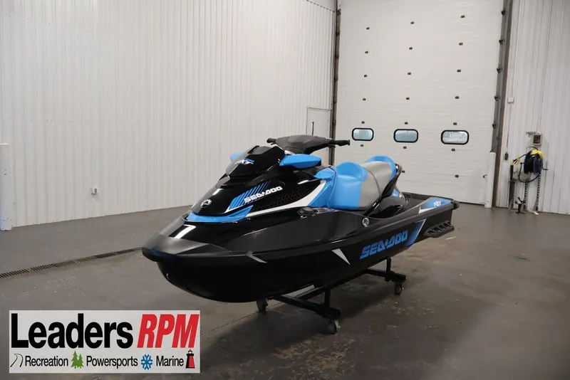 The Image of 2017 Sea-Doo RXT 260 jet ski in showroom, black and blue design. - 1