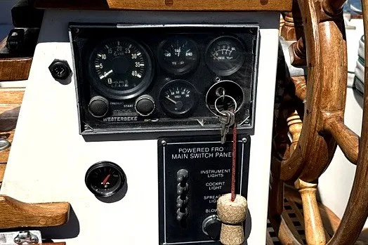 Slide: The Image of Dashboard of a 1988 Gozzard Cutter 36 sailboat with gauges and wooden wheel. - 28