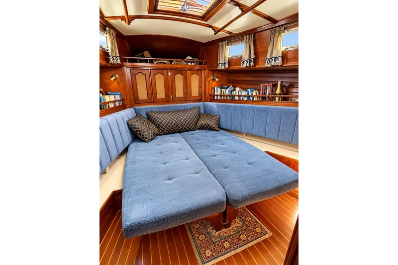 Slide: The Image of Luxurious interior of 1988 Gozzard Cutter 36 yacht with blue upholstery and wooden accents. - 23