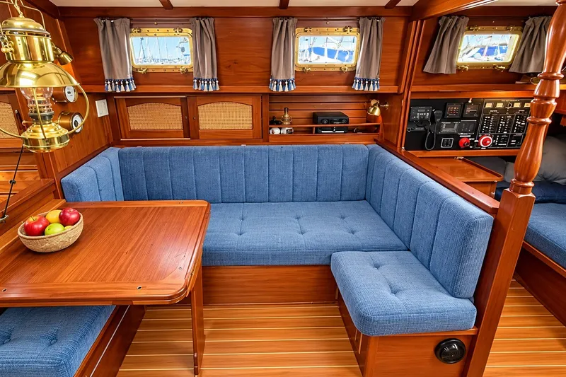 Slide: The Image of Interior of 1988 Gozzard Cutter 36 with blue upholstery and wooden accents. - 19
