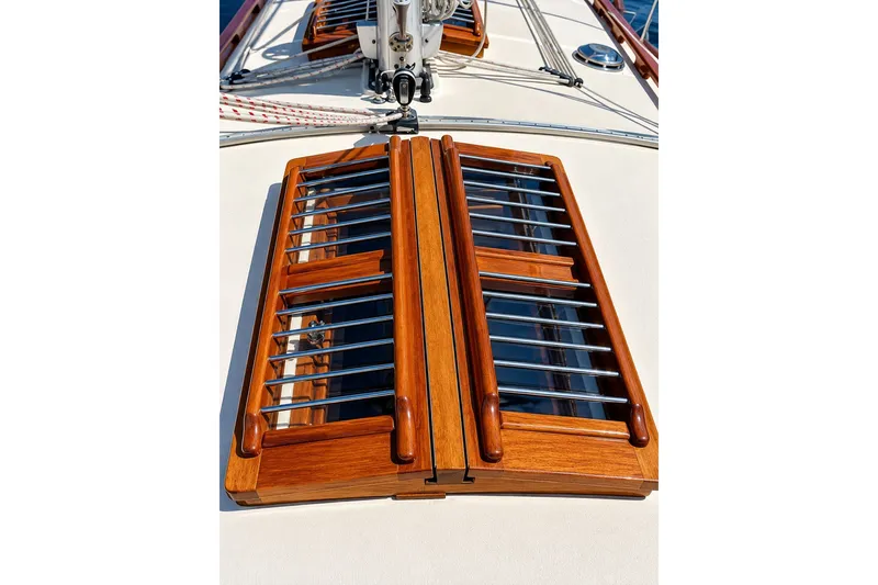 Slide: The Image of Wooden hatch on 1988 Gozzard Cutter 36 sailboat deck, featuring metal bars. - 13