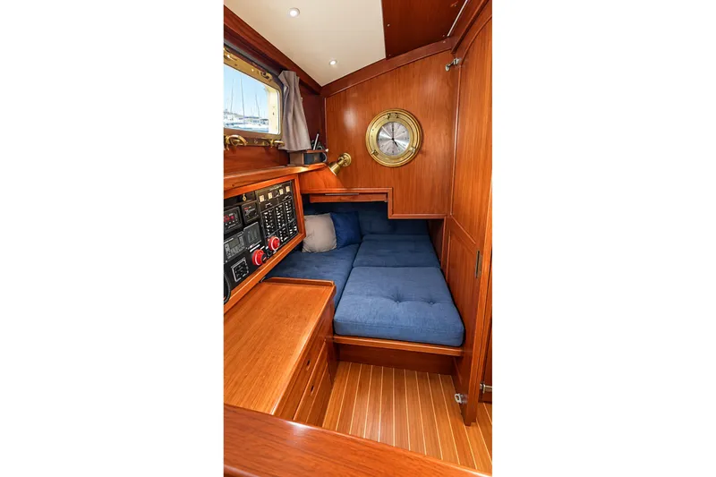 Slide: The Image of Cozy cabin interior of 1988 Gozzard Cutter 36 with blue cushions and wooden finish. - 17